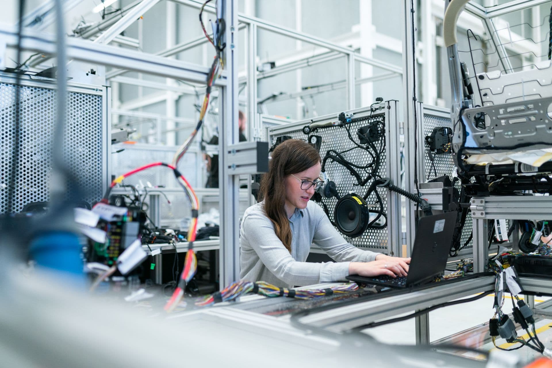 Professional engineer working on 3D plant design and piping models on multi-monitor workstation